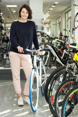 Fototapeta na wymiar woman showing with sport bicycle