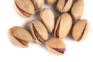 Heap of salted pistachio nuts isolated on a white background