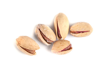 Heap of salted pistachio nuts isolated on a white background