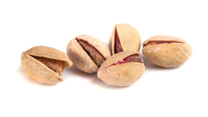 Heap of salted pistachio nuts isolated on a white background