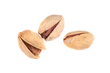 Heap of salted pistachio nuts isolated on a white background