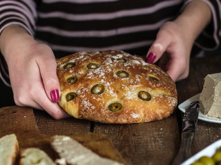 ciabatta - bread with olives on a wooden surface