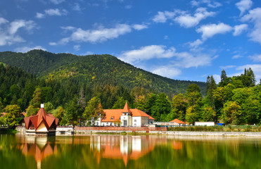 Beautiful landscape of Tusnad spa resort architecture reflected in Saint Ana lake in Romania