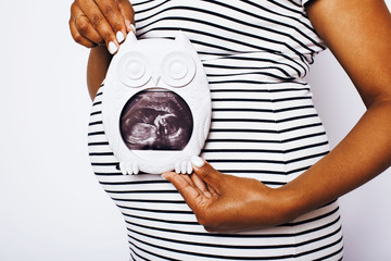 african american woman pregnant , posing on white background iso