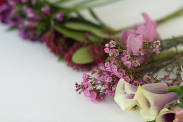 Floral concept. Different flowers on the white table in flower shop