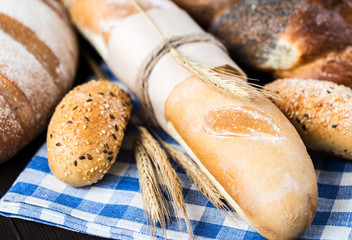 Fresh bread on table. Homemade bread. Kitchen or bakery poster design. Bread background