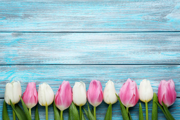 Bouquet of tulips on blue wooden table