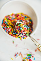 culinary sprinkling, cooking dressing in a Cup with a spoon on light background, close up