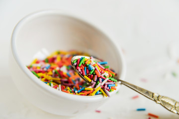 culinary sprinkling, cooking dressing in a Cup with a spoon on light background, close up