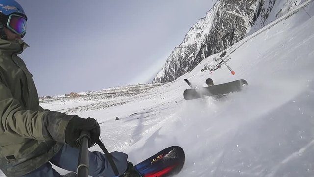 Snowboarder instructor and girl beginer falling at ski resort.