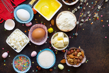 Ingredients for Easter baking - cottage cheese, nuts, eggs, flour, yeast, butter, raisins and sugar. Flat lay. Top view with copy space.