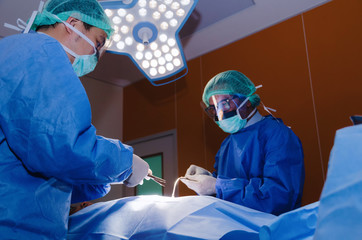 group of Doctor and Assistant surgeons work for rescue patient in operation room at hospital,...
