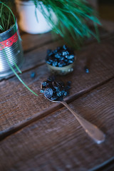 Still life of grapes and prunes on a wooden background.