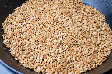 Roasted sunflower seeds in a black skillet