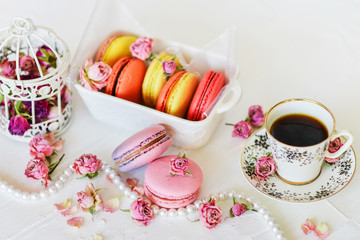 Delicate Fresh Colorful French Macaroons In Pastel Colors With Flowers Roses On A Light Textile Background