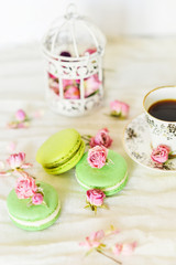 Dessert With Coffee: A Delicate Fresh French Macaroons In Pastel Colors Gift Box Flowers Roses On Light Blue Wooden Background