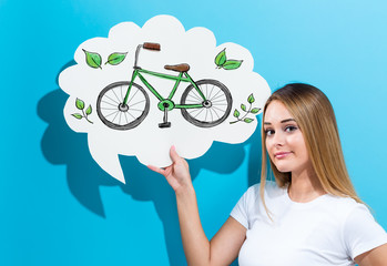 Eco Bicycle with young woman holding a speech bubble