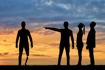 Crowd of people makes it clear to a disabled person with a leg prosthesis that he should go away. The concept of Discrimination of people with disabilities in society