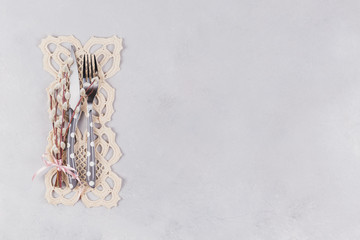 Cutlery, lace napkin and pussy willow twigs