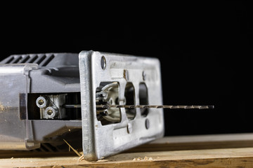 Carpentry tools on a wooden workshop table. Saw and other carpentry accessories while working in a carpentry workshop.