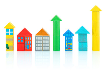 Houses and towers builded from colorful wooden blocks isolated on white background with shadow reflection. Children's wooden toys.