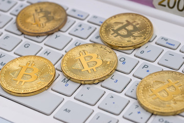bitcoin on white laptop close up
