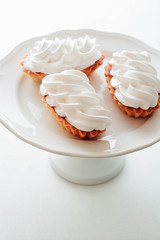 Delicious lemon tartlets with meringue on a white background.