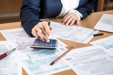 Woman filling US 1040 tax form 2018 year