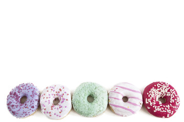 Colorful group of doughnuts on white. Top view.
