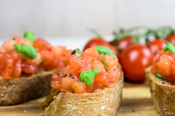 Slices of toasted baguette with tomato - bruschetta - close up