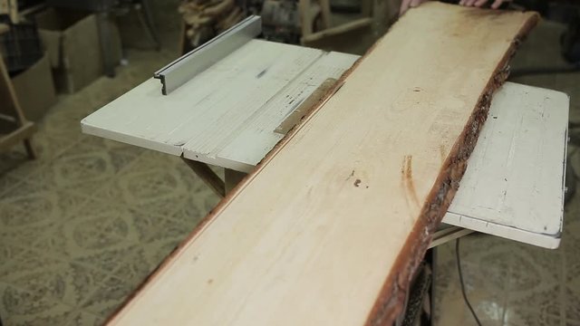Circular table saw cutting wood in carpenter workshop