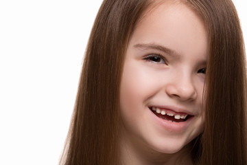 Beautiful little girl caucasian with long dark hair happy smiling on studio. Isolated white background