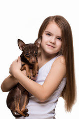Beautiful young girl with cute terrier dog, isolated on white.