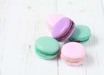 Macaron or macaroon on white background, colorful almond cookies with different filling. Selective focus on some macaroons