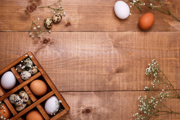 Eggs in wooden box on the table. Top view, text space