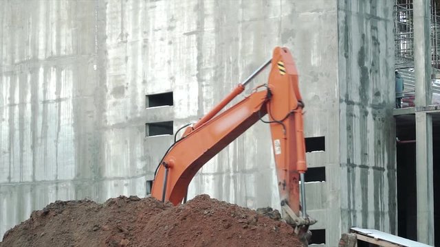 Loader backhoe, excavator digging a trench. Clip. Work of excavating machine on building construction site. Excavator digs a hole