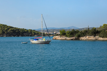 Fototapeta na wymiar A sailing boat anchoring in a bay near Porto Heli, Peloponnese, Greece.
