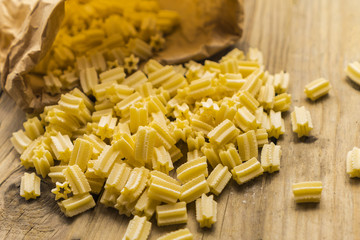 pasta scattered on an old wooden table
