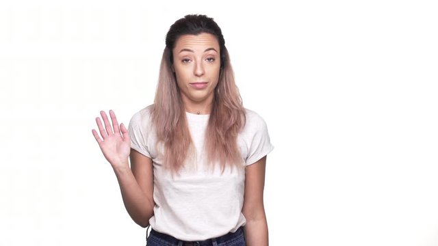 Studio portrait of caucasian woman in casual t-shirt expressing disinterest and perplexity while receiving proposal, over white background closeup. Concept of emotions