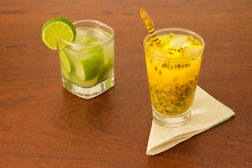 Glass with Lemon and Passion Fruit Caipirinha made with brazilian cachaca. In the wood table napkin - Brazilian National Drink - 