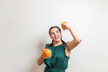 Happy smiling teen tries to lift fruits