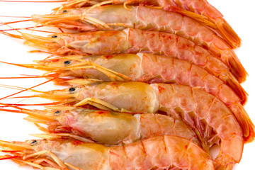 Obraz na płótnie Canvas Raw prawns on a white background. Shrimp langoustina close-up on a white surface.