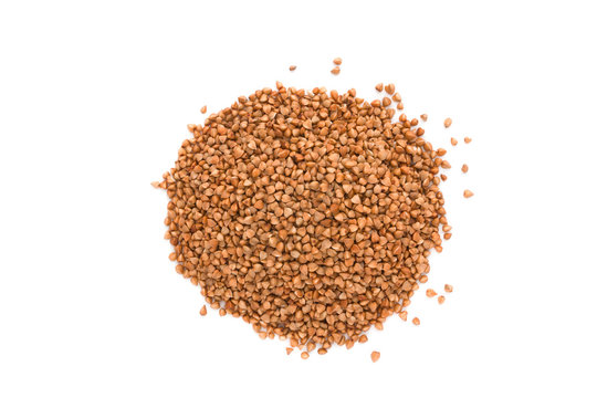 Buckwheat on white background. Pile of buckwheat groats close-up on a white background.
