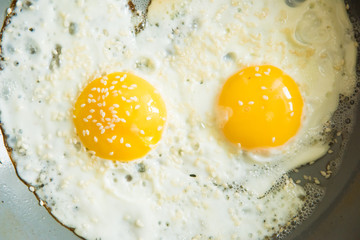 Fried eggs for breakfast early in the morning. Scrambled eggs with spices