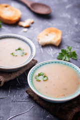 Healthy vegetarian peas soup on concrete background