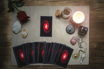 Tarot cards and rose flower on fortune teller desk table background. Future reading. Love or romantic divination concept.