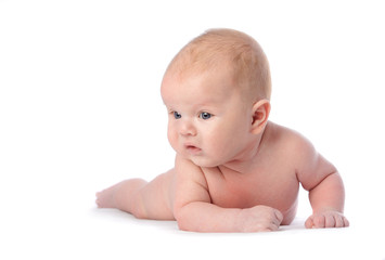 Baby with grey eyes lying and looking, isolated on white
