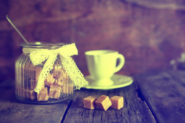 toned photo tea cup with sugar cubes