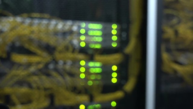 Rack Mounted Servers In A Server Room, Server rack audio cable. Severs computer in a rack at the large data center. Fiber Optical connector interface. Flashing lights blurred background - Powered by Adobe