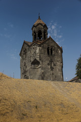 Fototapeta na wymiar Three navesthe bell tower with the umbrella dome in the monastery of Gregory in Armenian village of Haghpat